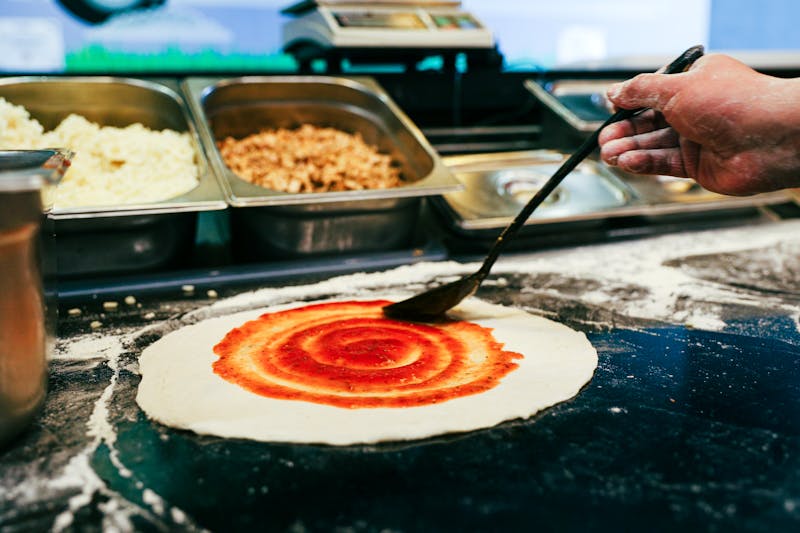 Pizza Ranch kitchen — freshly made ranch pizza being prepared